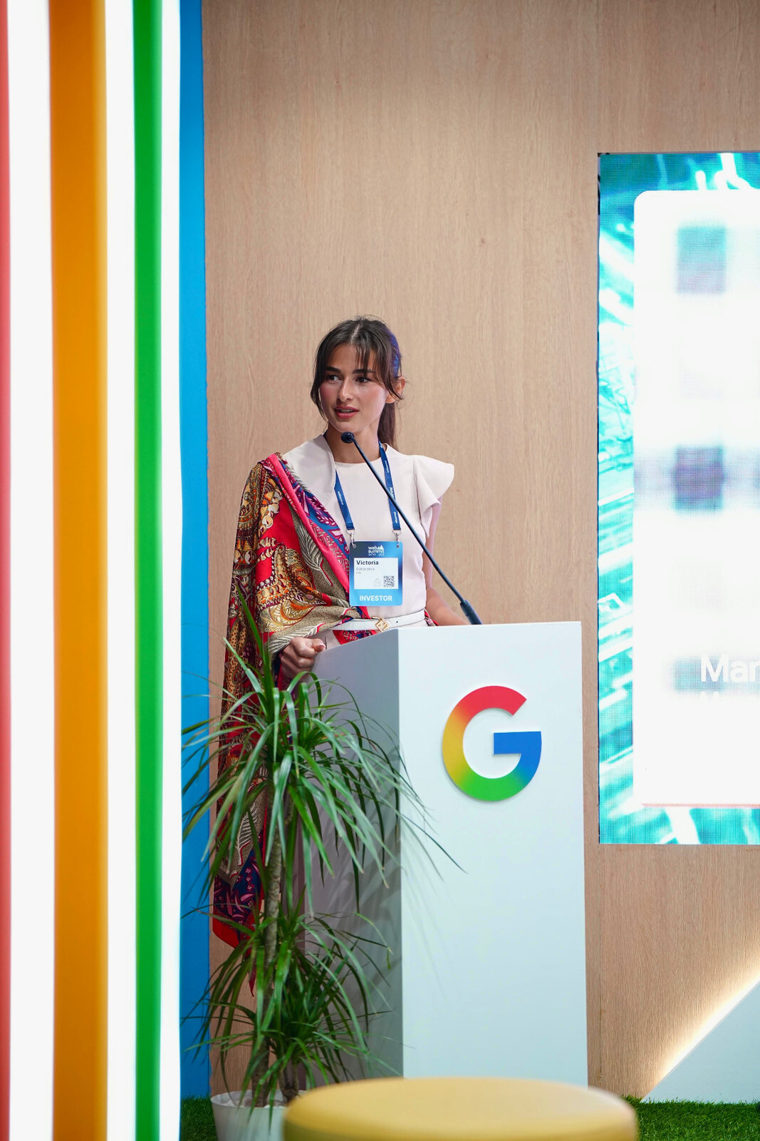 Speaking at a podium during a technology summit